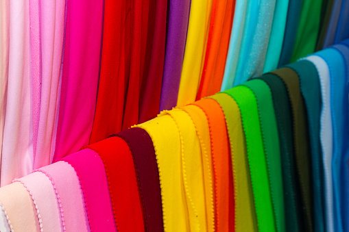 Colorful fabrics on the counter of the store. Sale